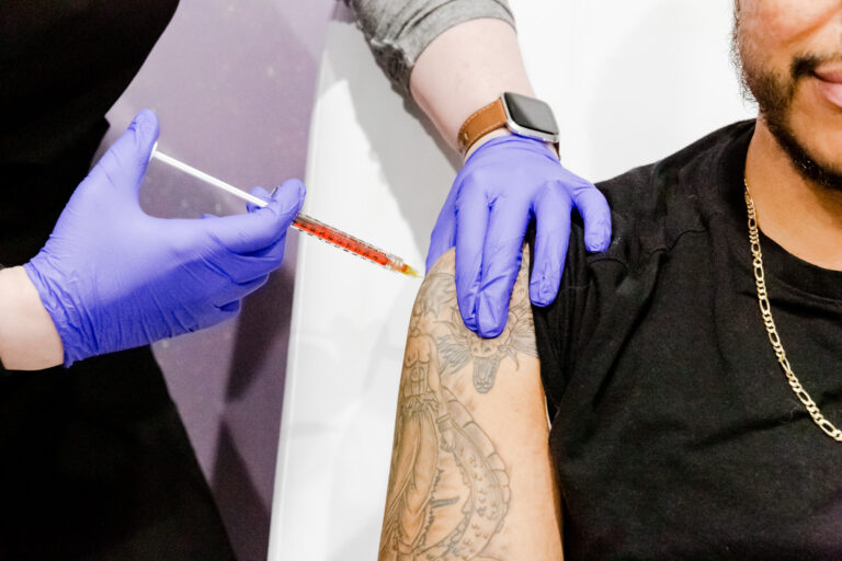 A man gets a vitamin injection at his appointment for injectables in McLean