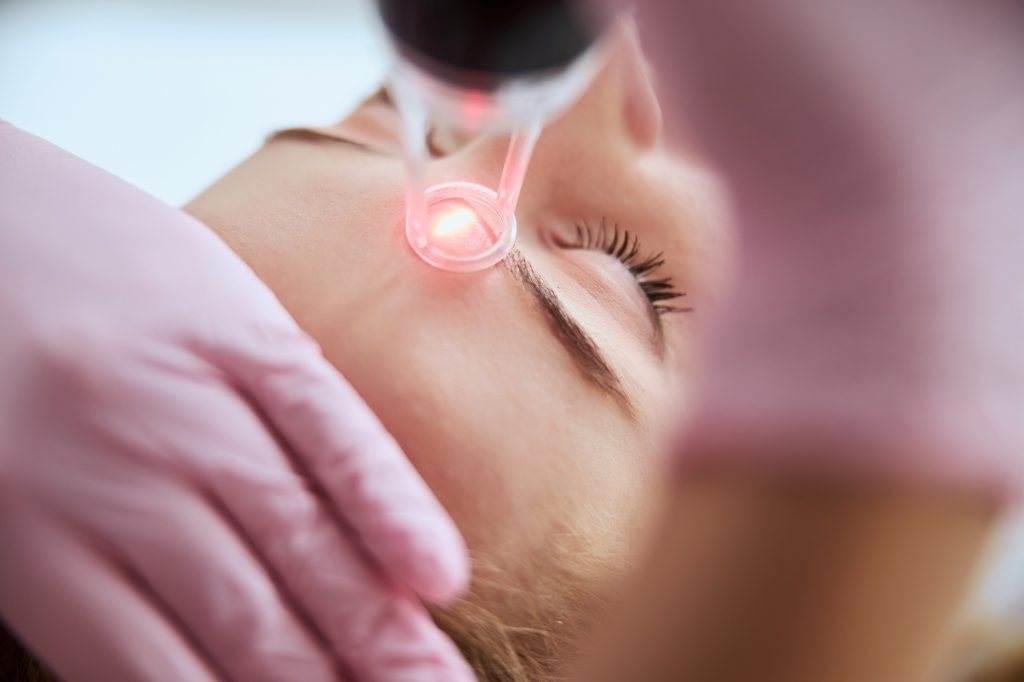 A McLean Laser Center dermatologist performing a laser resurfacing procedure.